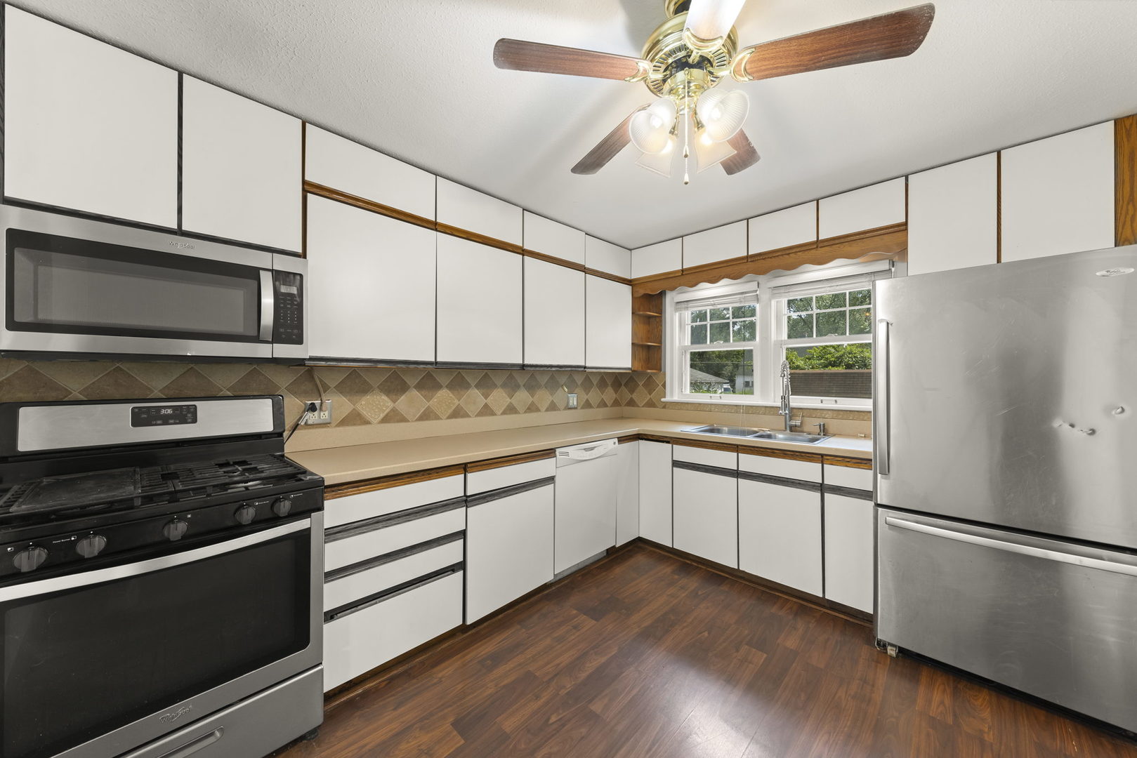 1204 Oneida Street Joliet, IL 60435 - Photo 10 of 30 a kitchen with granite countertop a refrigerator and a stove top oven