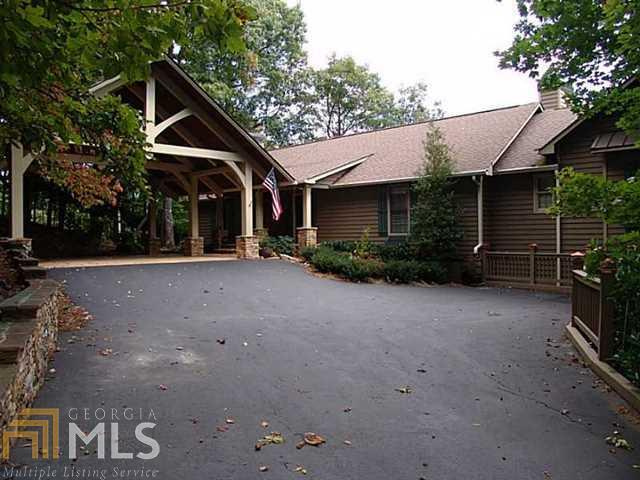 Stone Wall Lined Driveway to oversized 2 car porte-cochere at front entry. An additional climate controlled, 2 car garage is another amenity of this home
