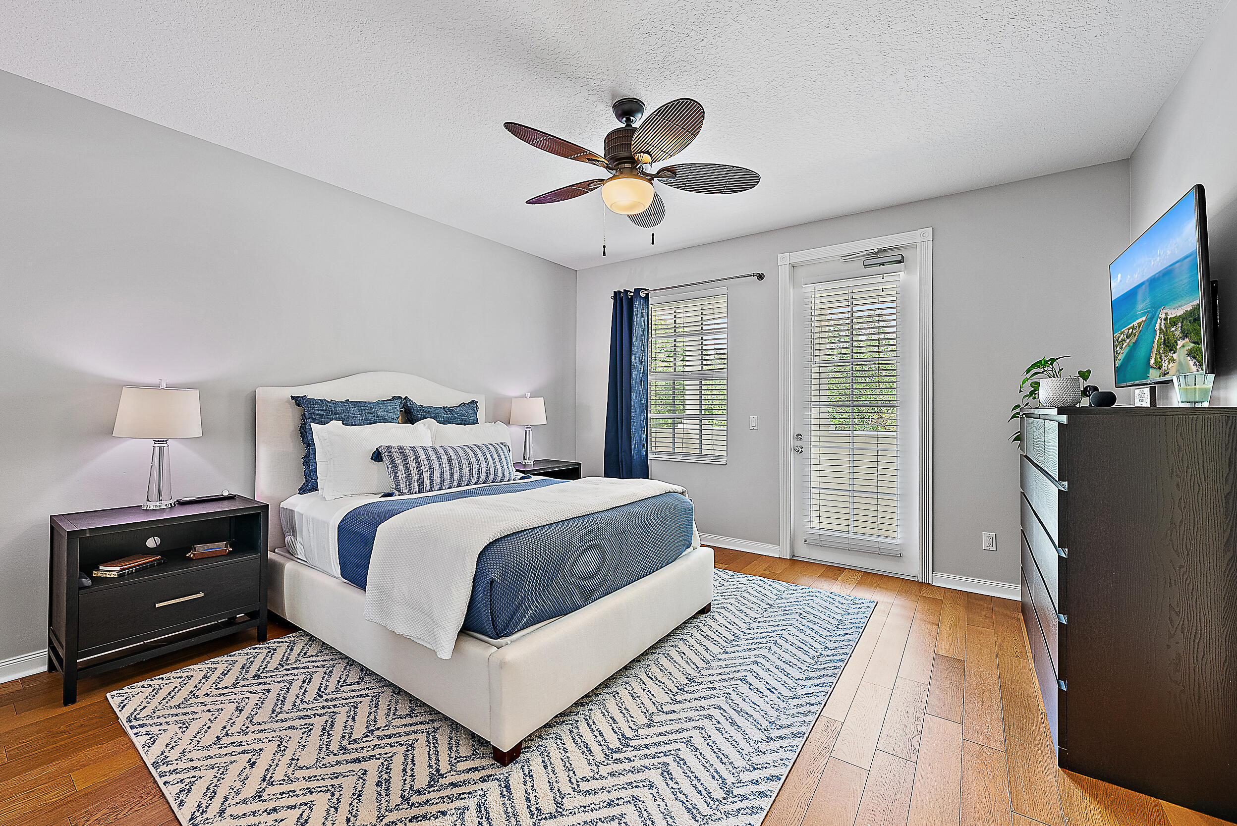 107 Rivinia Drive Jupiter, FL 33458 - Photo 5 of 28 a bedroom with a bed and wooden floor