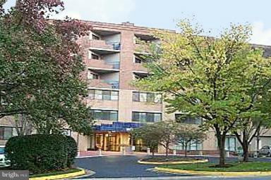 1951 Sagewood Lane, Unit 214 Reston, VA 20191 - Photo 1 of 23 a front view of a building with trees