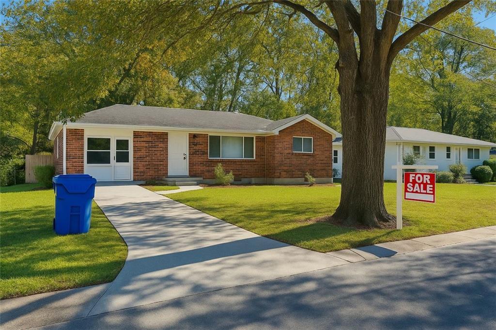 2043 Claude Street Northwest Atlanta, GA 30318 - Photo 1 of 1 a front view of a house with a garden and yard