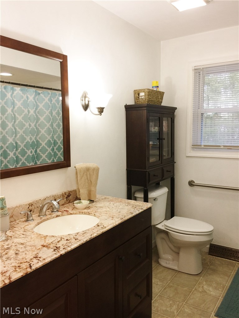 7901 Race Road North Ridgeville, OH 44039 - Photo 11 of 35 Remodeled full bath has granite vanity lots of natural light.