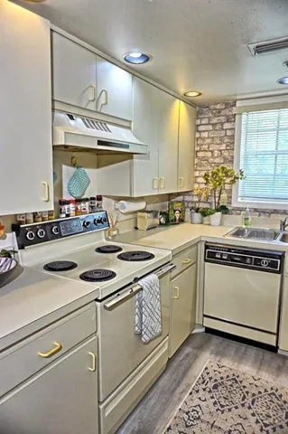 a kitchen with a stove a sink and a microwave