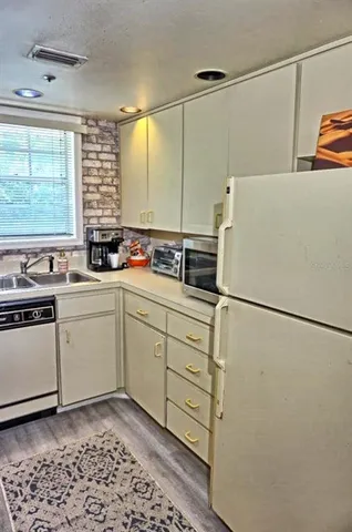 a utility room with sink dryer and washer