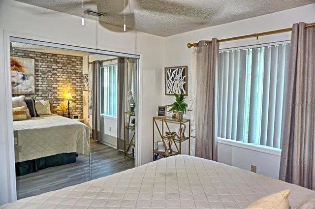 a bedroom with a large bed and a large window