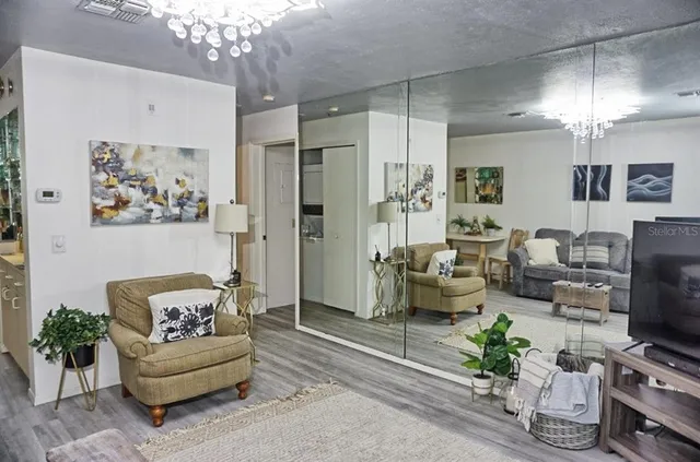 a living room with furniture and a chandelier