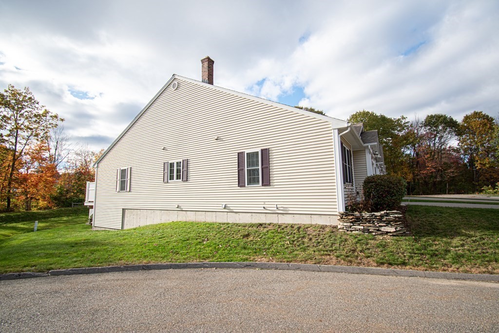 26 Mark Circle, Unit 26 Rutland, MA 01543 - Photo 20 of 26 a front view of a house with a garden
