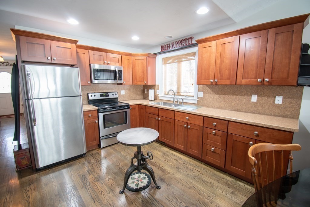 26 Mark Circle, Unit 26 Rutland, MA 01543 - Photo 3 of 26 a kitchen with a refrigerator a sink cabinets and wooden floor