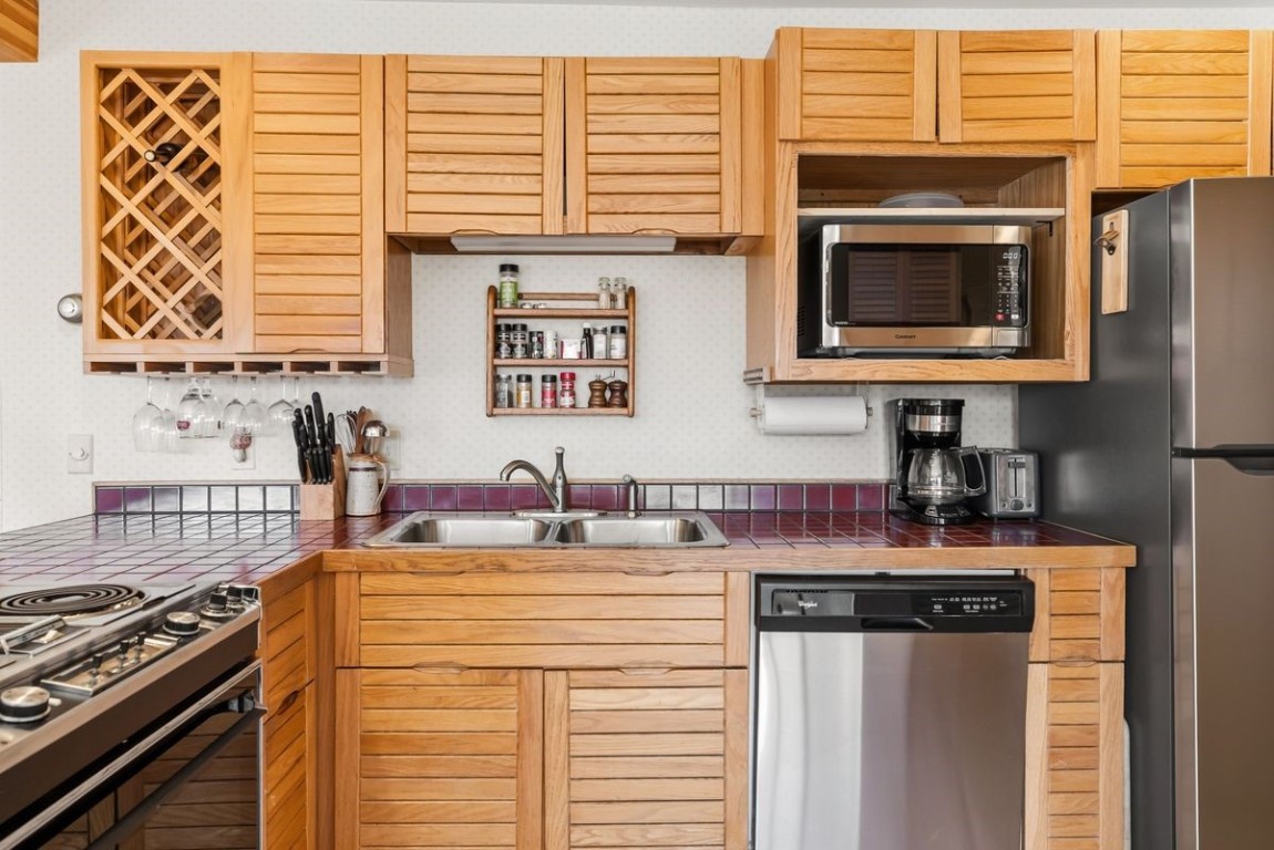 91300 Ryan Gulch Road, Unit 91311 Silverthorne, CO 80498 - Photo 12 of 28 a kitchen with a stove and a sink
