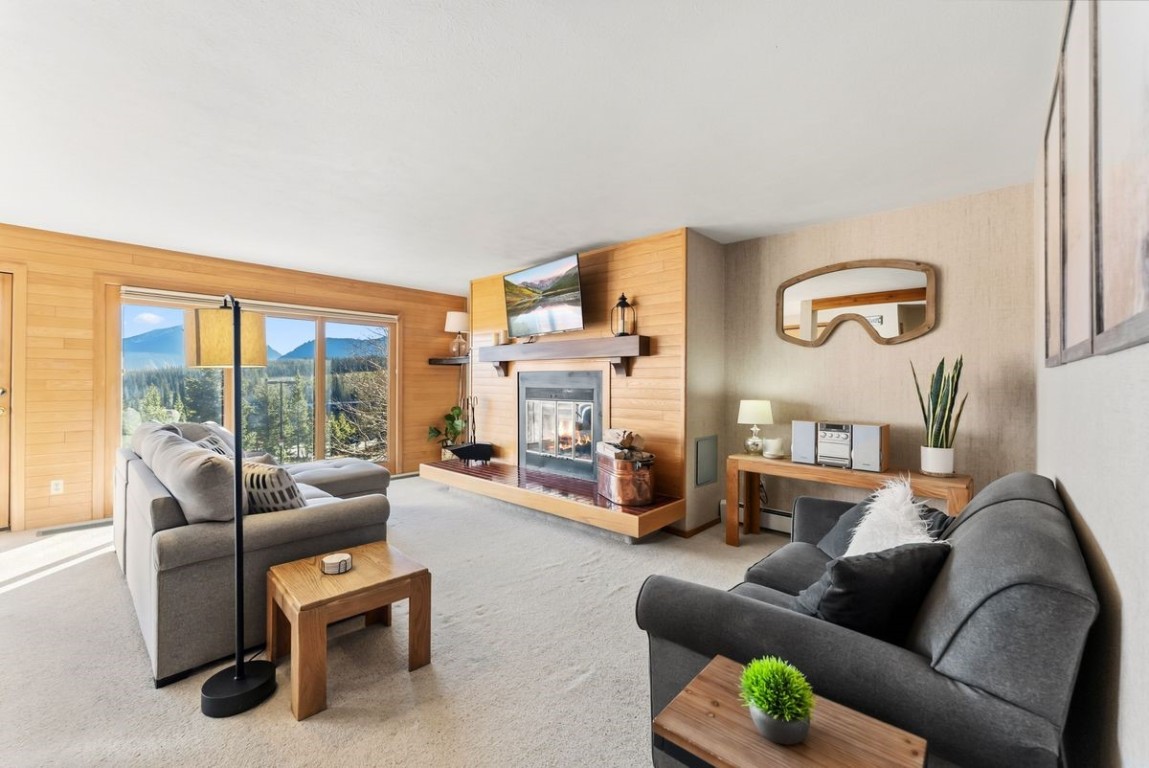 91300 Ryan Gulch Road, Unit 91311 Silverthorne, CO 80498 - Photo 15 of 28 a living room with furniture and a large window