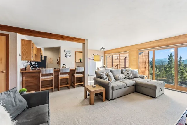 a living room with furniture and large windows