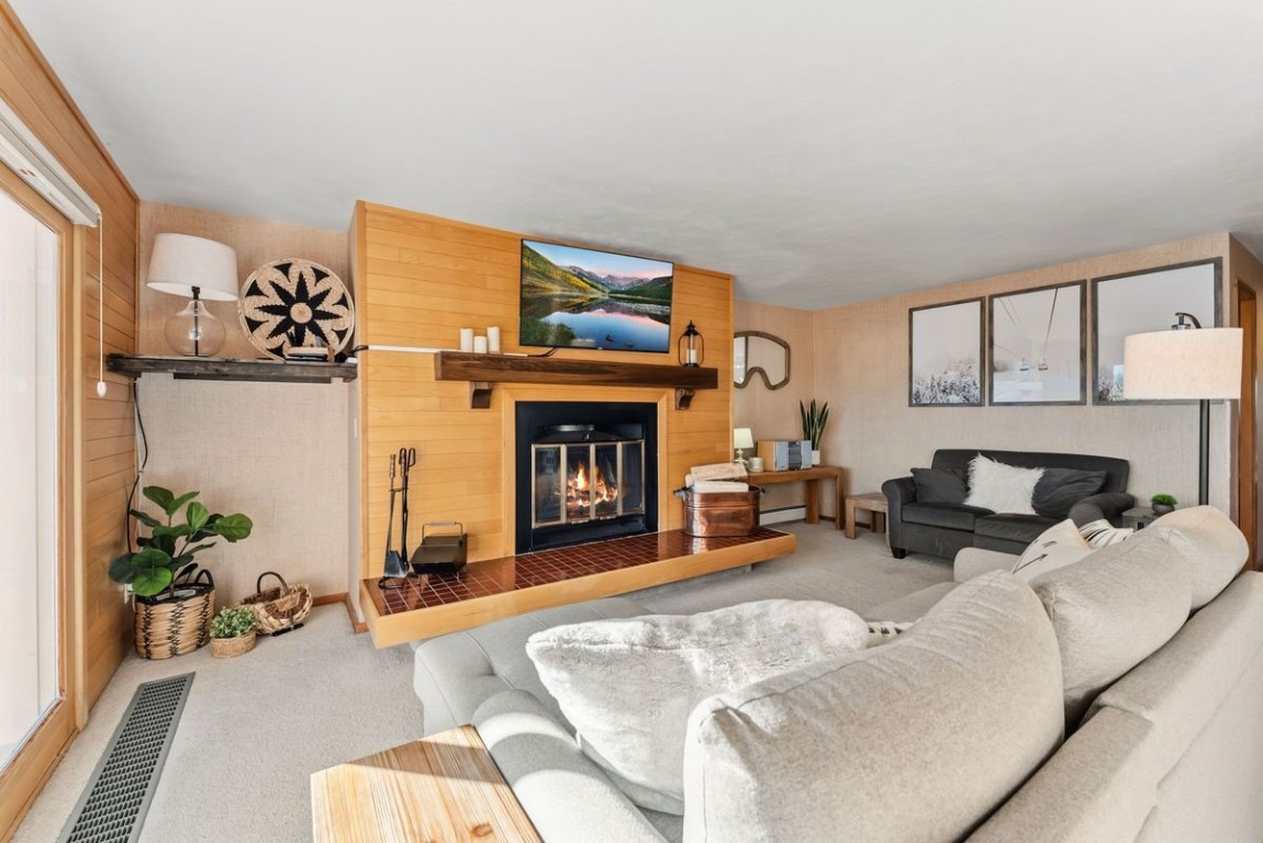 91300 Ryan Gulch Road, Unit 91311 Silverthorne, CO 80498 - Photo 10 of 28 a living room with furniture and a fireplace