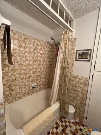 a bathroom with a bathtub and shower