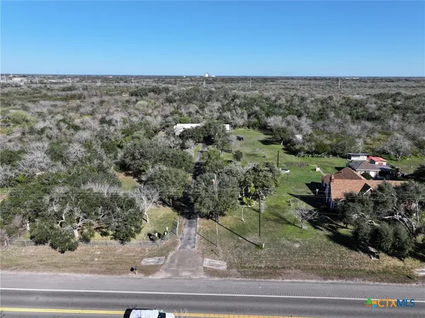 an aerial view of a house with a yard