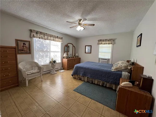 a bedroom with a bed and glass windows