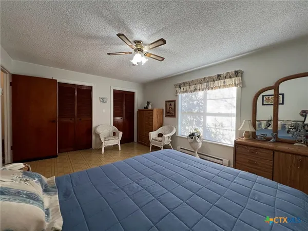 a bedroom with a bed and a dresser