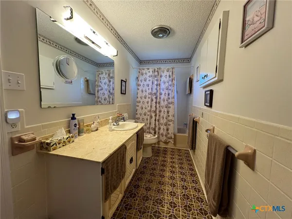 a bathroom with a sink a mirror and a shower
