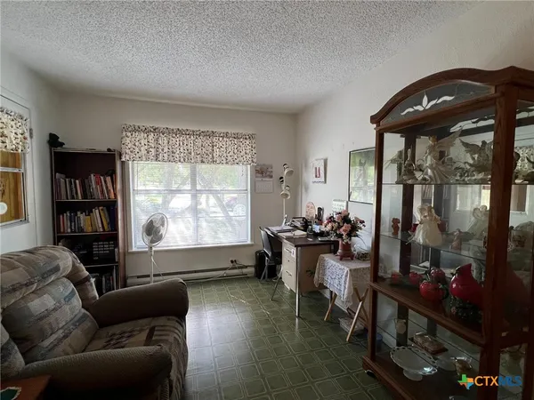 a living room with furniture and a floor to ceiling window