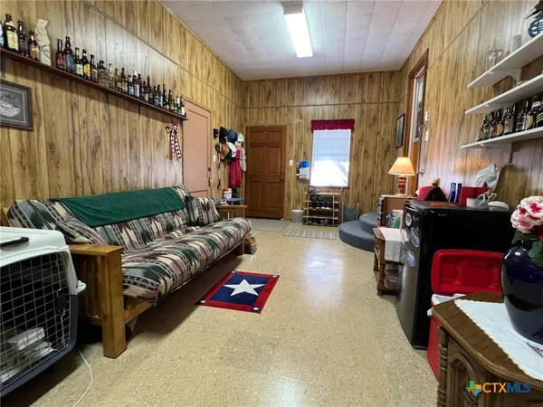 a living room with furniture fireplace and a window