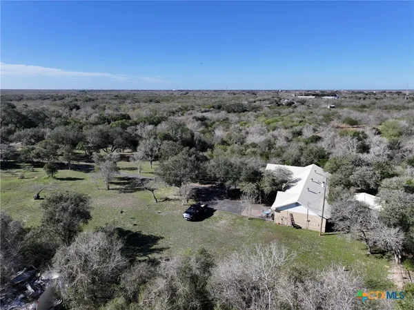 an aerial view of a house with a yard