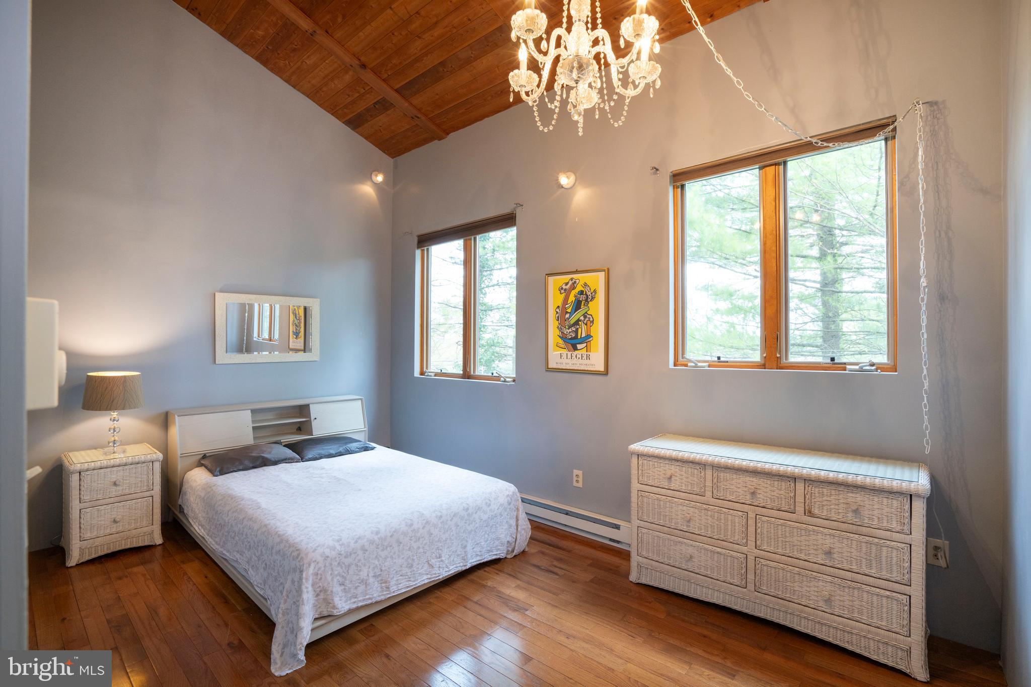 854 Thomas Street State College, PA 16803 - Photo 55 of 82 a bedroom with a large bed and a chandelier