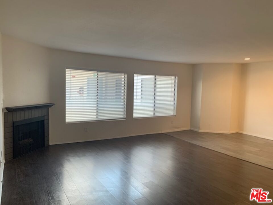 4353 Coldwater Canyon Avenue, Unit 305 Studio City, CA 91604 - Photo 12 of 27 an empty room with wooden floor and windows