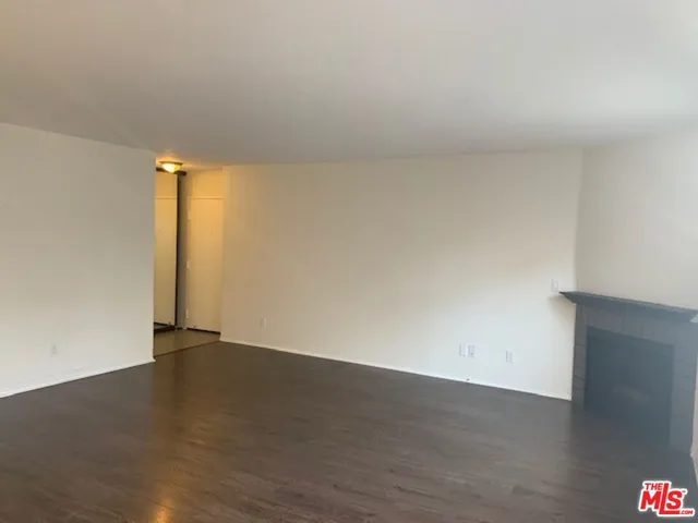 a view of an empty room and wooden floor