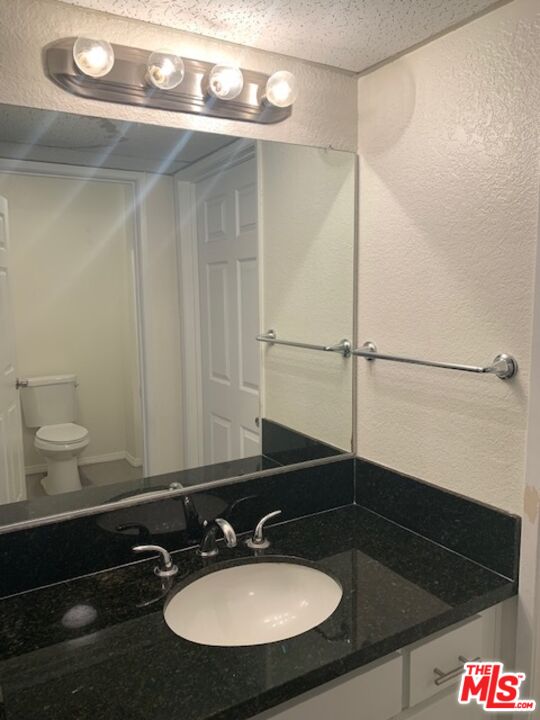 4353 Coldwater Canyon Avenue, Unit 305 Studio City, CA 91604 - Photo 15 of 27 a bathroom with a sink and a mirror