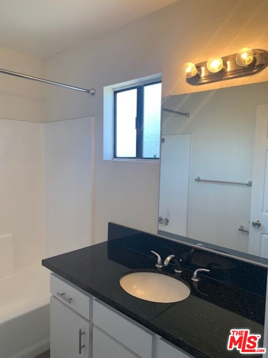 4353 Coldwater Canyon Avenue, Unit 305 Studio City, CA 91604 - Photo 18 of 27 a bathroom with a sink and a mirror