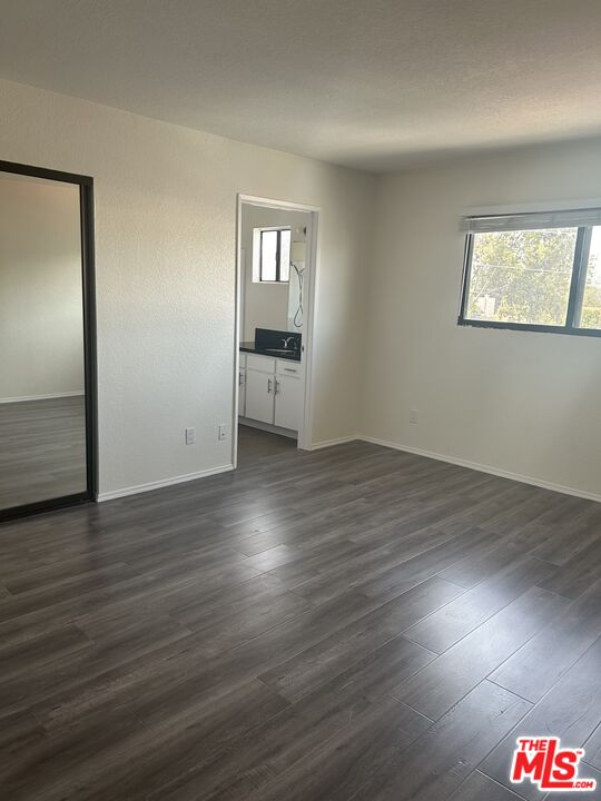 4353 Coldwater Canyon Avenue, Unit 305 Studio City, CA 91604 - Photo 20 of 27 an empty room with wooden floor mirror and windows