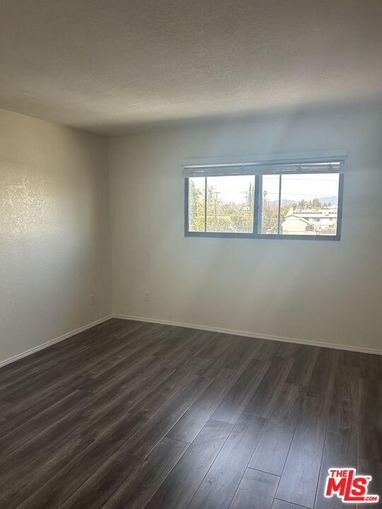 4353 Coldwater Canyon Avenue, Unit 305 Studio City, CA 91604 - Photo 21 of 27 an empty room with wooden floor and windows