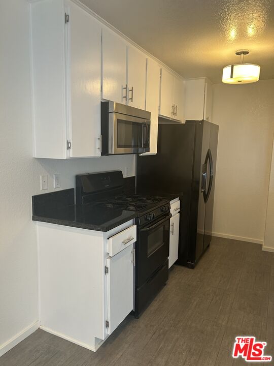 4353 Coldwater Canyon Avenue, Unit 305 Studio City, CA 91604 - Photo 22 of 27 a kitchen with granite countertop a refrigerator and a stove