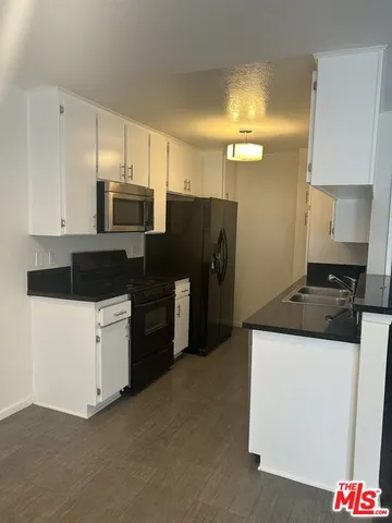 an empty room with wooden floor and closet