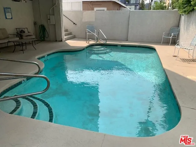 a view of a swimming pool with a outdoor seating area