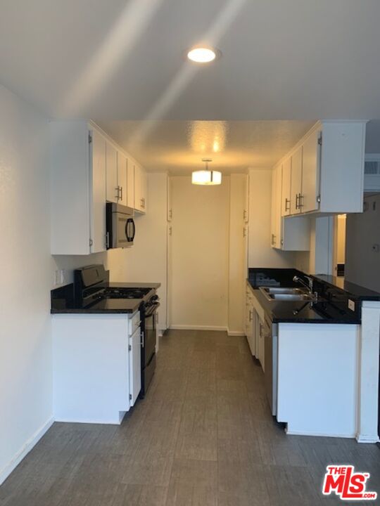4353 Coldwater Canyon Avenue, Unit 305 Studio City, CA 91604 - Photo 8 of 27 a kitchen with granite countertop a sink and a stove top oven