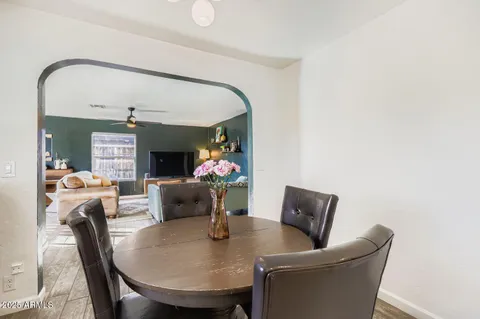 a dining room with furniture and a mirror