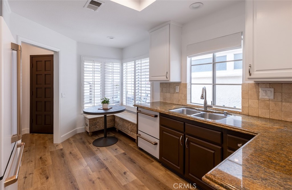 20 St Michael Dana Point, CA 92629 - Photo 12 of 43 a kitchen with a sink and wooden cabinets