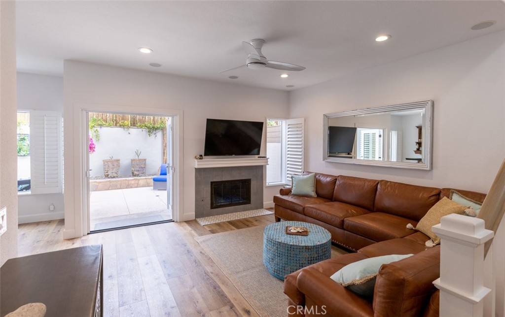 20 St Michael Dana Point, CA 92629 - Photo 5 of 43 a living room with furniture a flat screen tv and a fireplace
