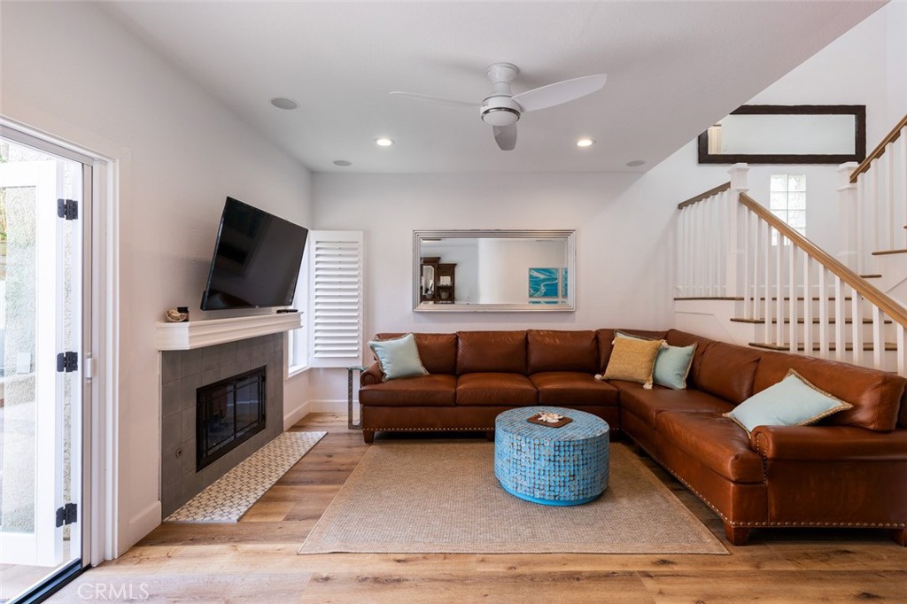 20 St Michael Dana Point, CA 92629 - Photo 6 of 43 a living room with furniture flat screen tv and a fireplace