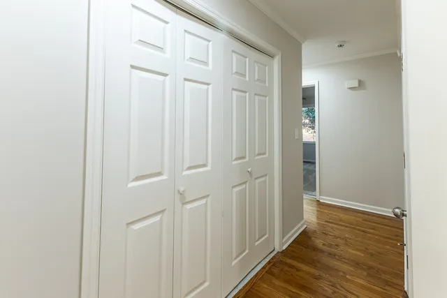 a view of a hallway with wooden floor