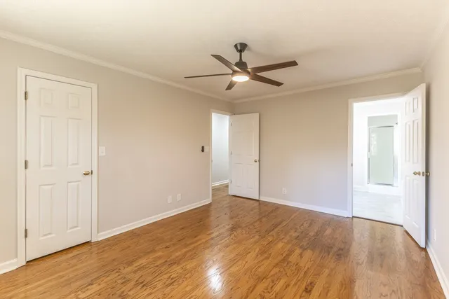 a view of an empty room and wooden floor