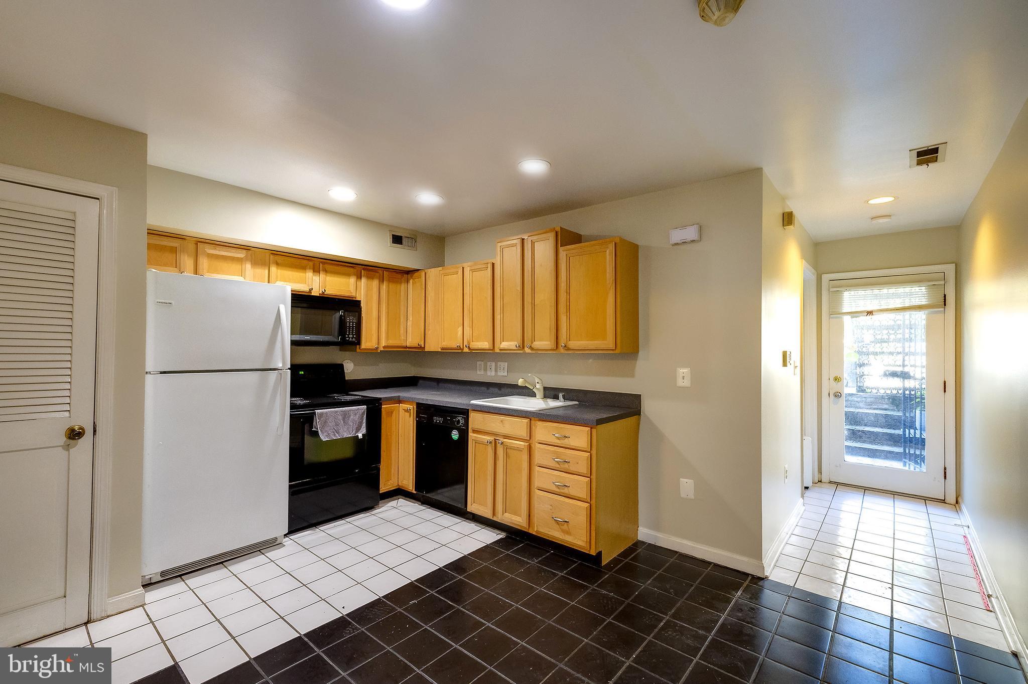 2025 11th Street Northwest Washington, DC 20001 - Photo 9 of 21 a kitchen with stainless steel appliances granite countertop a refrigerator stove and sink