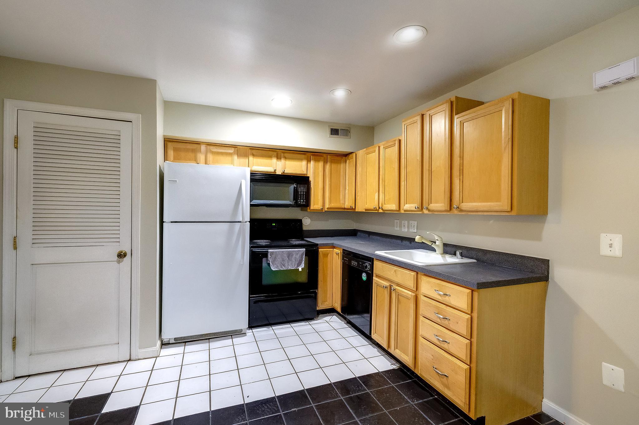2025 11th Street Northwest Washington, DC 20001 - Photo 10 of 21 a kitchen with stainless steel appliances granite countertop a refrigerator and a stove