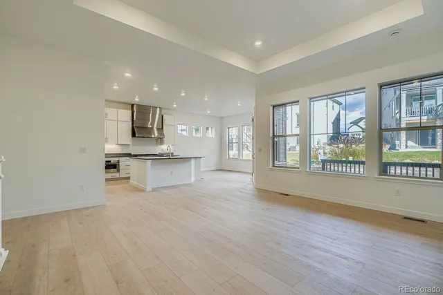 a view of an empty room with kitchen appliances and a window