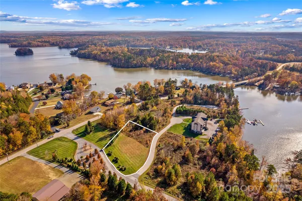 an aerial view of a house with a lake view
