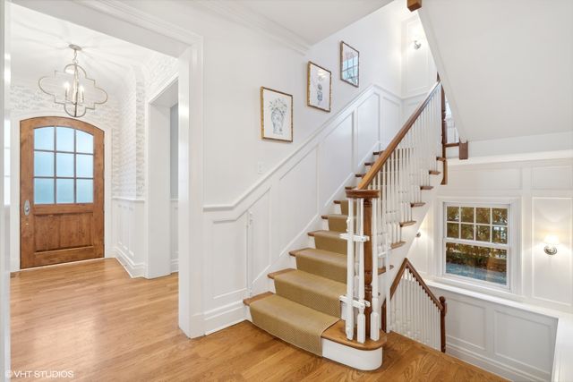 a view of entryway and hall with wooden floor