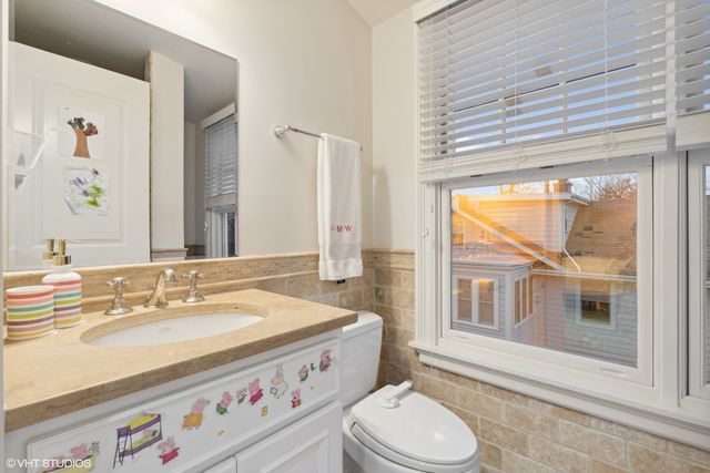a bathroom with a sink a toilet and a shower curtain