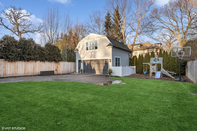 a view of a back yard with large trees