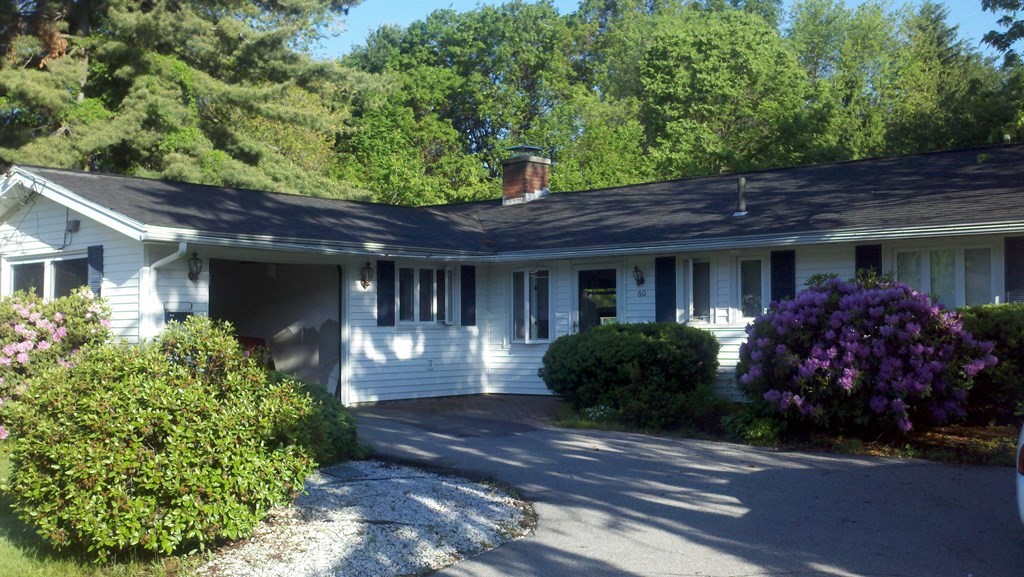 60 Gregory Road Framingham, MA 01701 - Photo 1 of 14 a front view of a house with garden