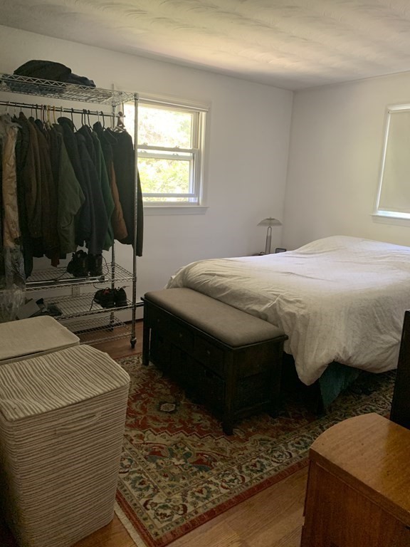 60 Gregory Road Framingham, MA 01701 - Photo 11 of 14 a bedroom with a bed a mirror and a window